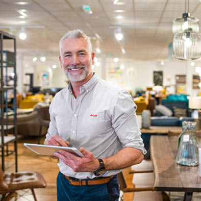 A close up portrait of a mature store manager stood in his workplace in Newcastle upon Tyne in the North East of England