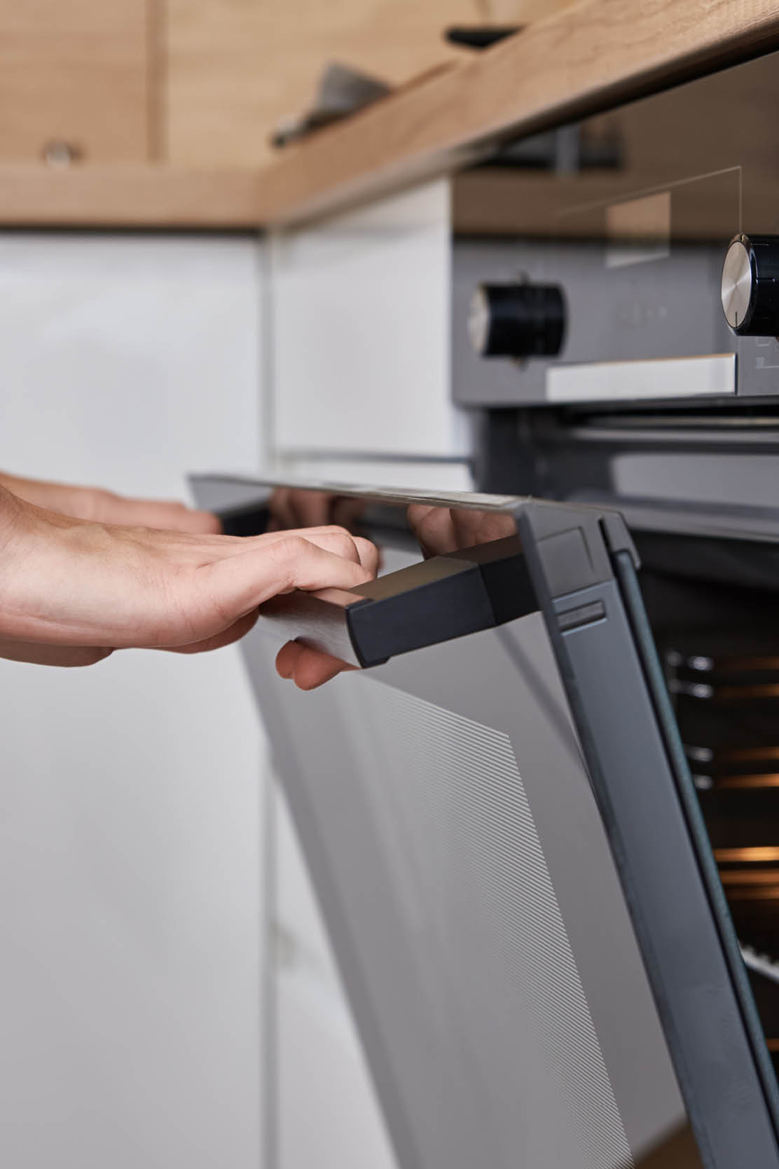 Woman hand open electric oven door with handle. Homemade cooking. Kitchen appliance